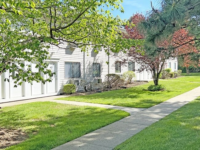 Lush green lawn area in front of apartments