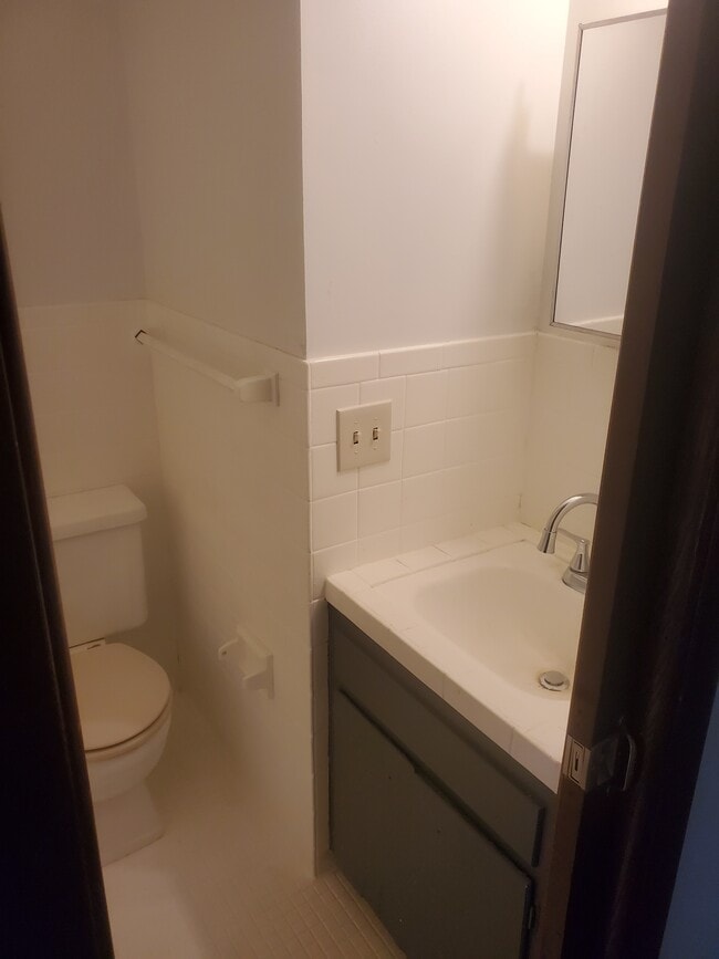 Full Bathroom Toilet and sink linen closet right outside of bathroom with lots of storage