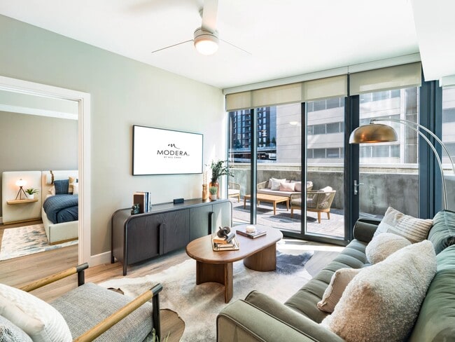 An airy living room at Modera McGavock, opening to a private terrace and city views, with Nashville’s dining and entertainment close at hand.
