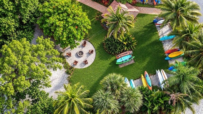 Unwind in the serene surroundings of Manatee Bay, where lush greenery meets stylish outdoor living. Enjoy fire pits, sun loungers, and vibrant social spaces designed for relaxation and fun. Explore your perfect escape today!