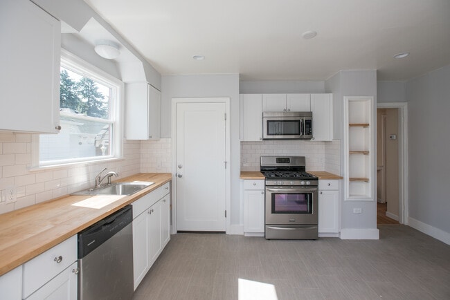 New counter tops and new cabinets. Tons of kitchen storage. - 2628 Northeast Ainsworth Street House Unit A