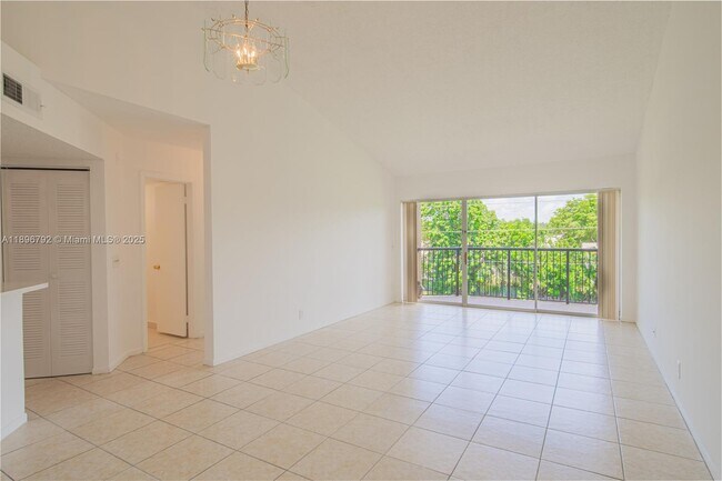 Building Photo - 9033 Wiles Rd Unit 303