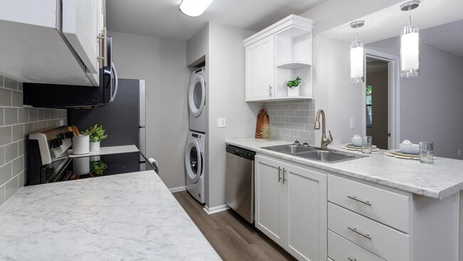 Premiere kitchens dressed in marble-style countertops, a chic tile backsplash, and a breakfast bar to cherish.