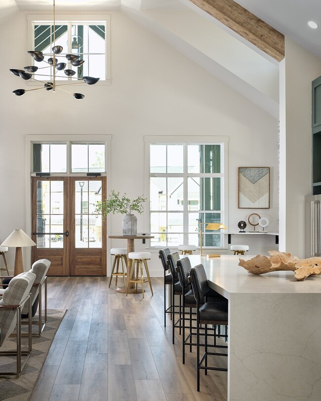 Inviting clubhouse space bathed in natural light with modern seating throughout.