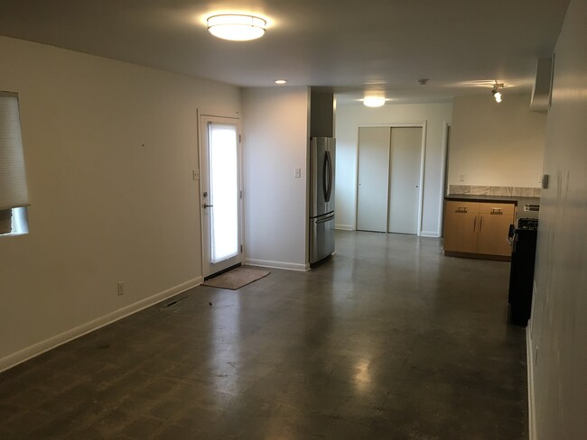 Front entrance to open kitchen, living, dining - 565 K St E Townhome