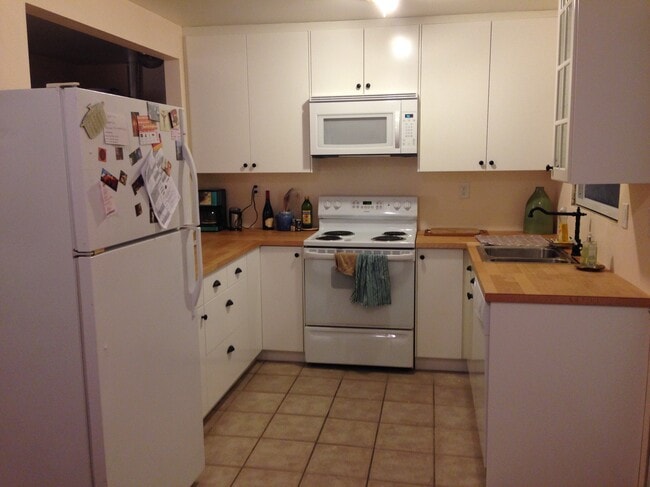 New kitchen with butcher block counter top and appliances. - 9313 North Hodge Avenue