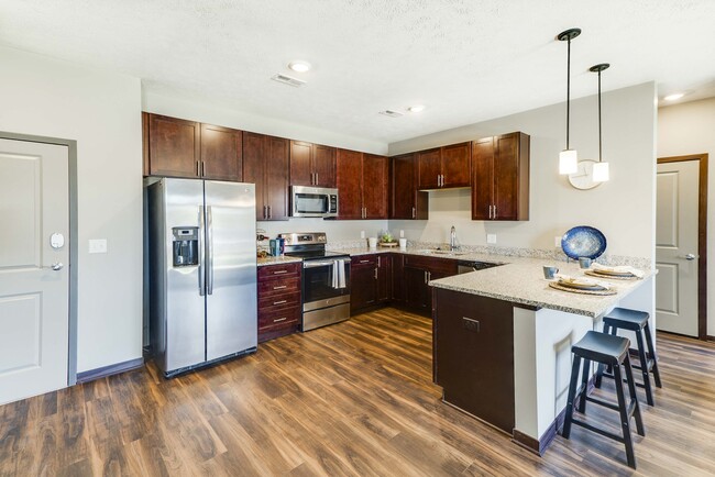 Our kitchens combine functionality and style with plenty of storage and modern appliances to enhance your culinary experience. - 360 at Jordan West Apartamentos