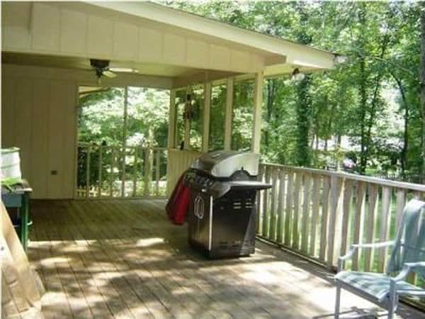Large back deck has a ceiling fan in the covered portion - 303 Ferncliff Dr Unit A