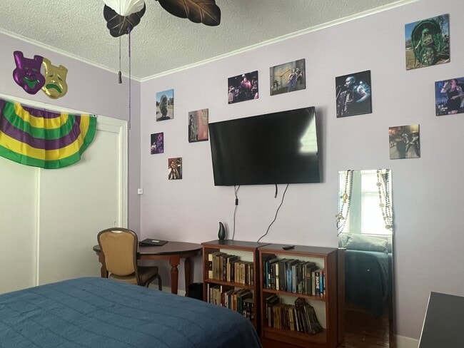TV and musician photos in bedroom