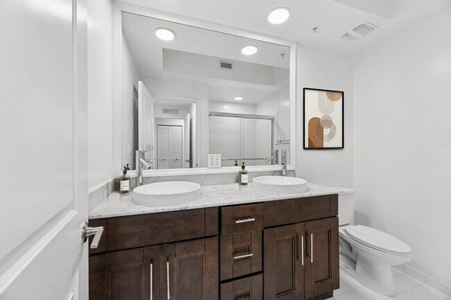 Renovated Package II bath with quartz countertop and oak cabinetry (in most homes)