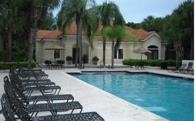 here are tables and lounge chairs around both pools. - 550 S Park Rd Unit 815