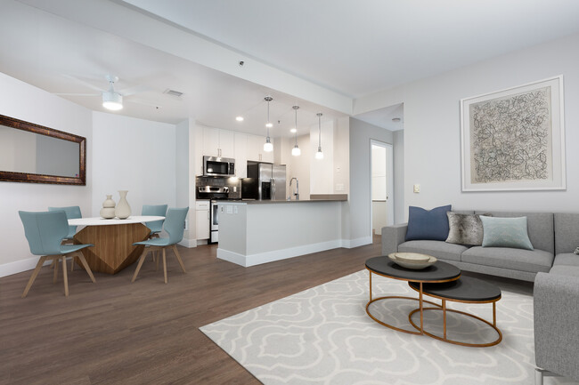 Renovated Phase I kitchen with quartz countertops, tile backsplash, and stainless steel appliances - Avalon at Mission Bay Apartments