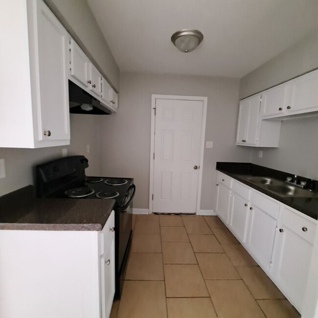 Photo - This 2BR/1BA includes a nice-sized living area, an ample kitchen, a fenced-in