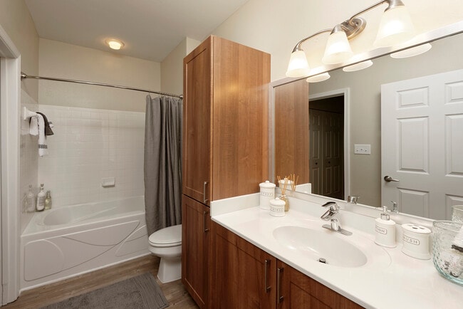 Hazelnut Finish Package bath with white countertop and hard surface flooring