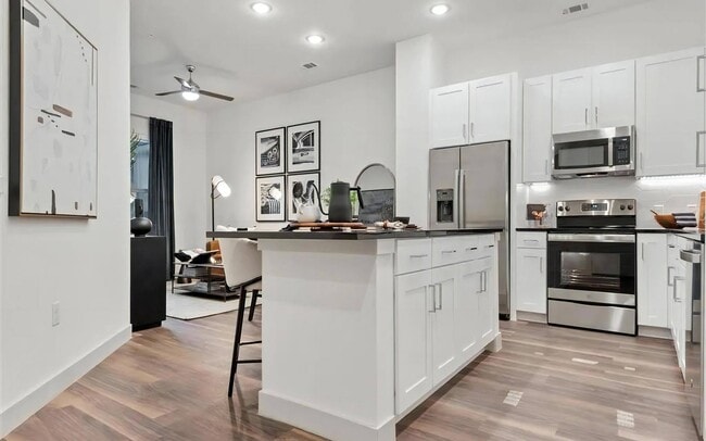 Apartment Interior with White Cabinets and Combined Living Space - The Elm at River Park Rental