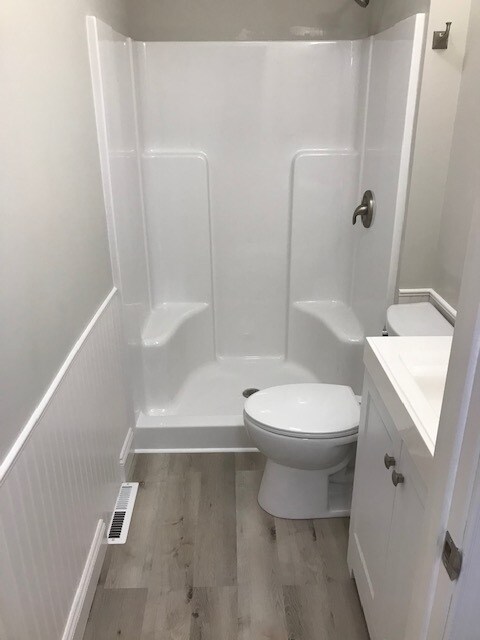 Bathroom features a walk in shower with wainscoting. - 9372 E Miami Ave