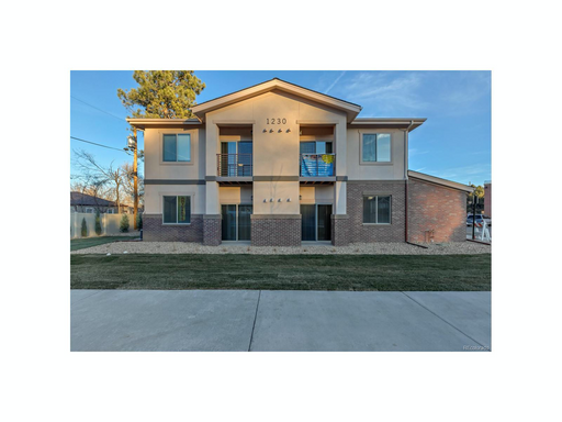Inviting two-story apartment building with a modern design and well-maintained landscape. - Two Creeks Crossing Apartments