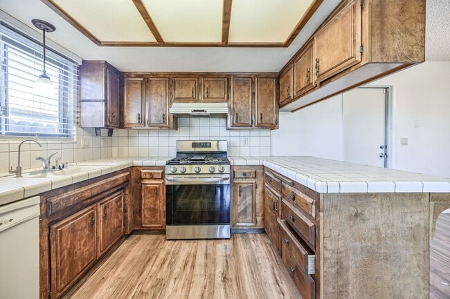 Photo - 3 bedroom, 2 bath with large living room and brick fireplace.  Good size kitchen with tons of cab...