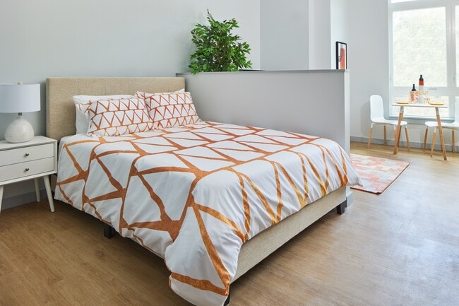 A studio apartment with designated bedroom area