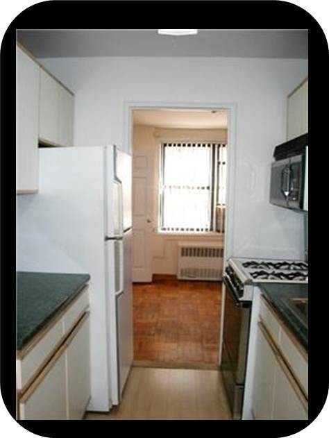 Galley kitchen looking to Bedroom #2 (Now has new gas range and microwave) - 6495 Broadway Unit Apt 2U