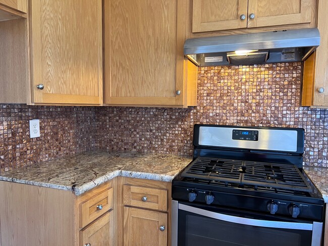 New stainless steel oven and beautiful Mother of Pearl backsplash - 2356 Canyon Park Dr Townhome