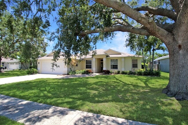 Photo - Annual rental: Spacious 3BR/2BA Creekwood Home with Office, Screened Lanai, EV Charger & Resort-S...
