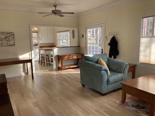 The bright and sunny great room features hard wood floors and comfy couches & chairs. - 831 Valencia St House