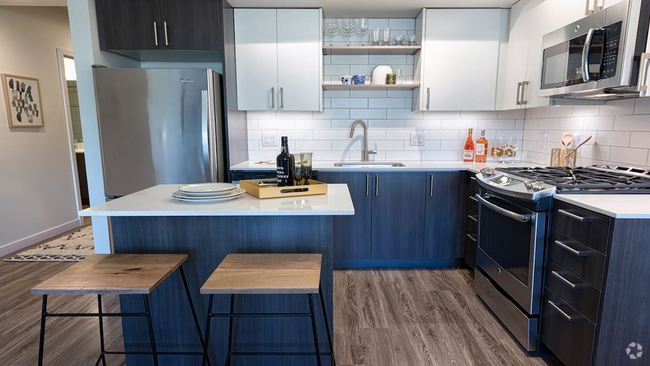 Our kitchens feature high-end finishes including stainless steel appliances and quartz countertops - Modera South Lake Union Rental