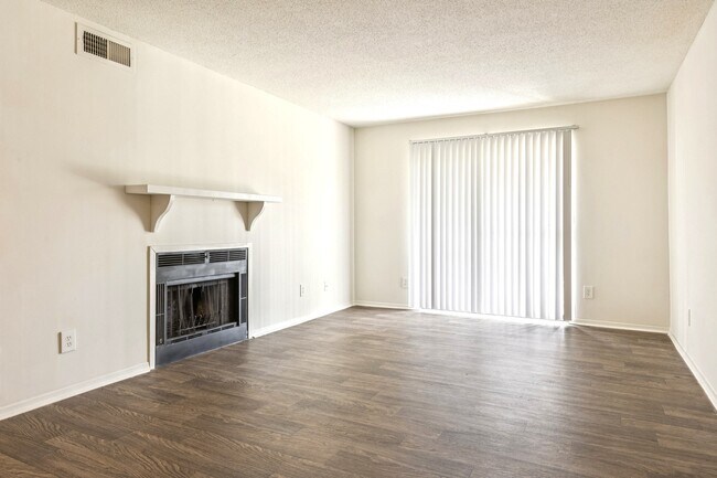 Generous living spaces feature a cozy fireplace and elegant hardwood flooring for comfortable entertaining, professionally operated by Highlands Vista Group.