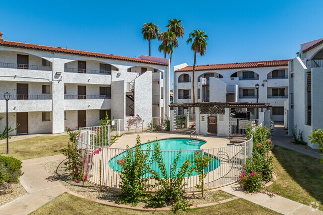 Enjoy the Bean-Shaped Pool and Outdoor Seating and BBQ Areas - Palm Aire Apartments