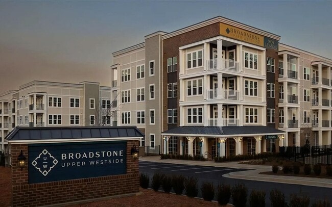 The leasing entrance sits at street level, right under the homes above.