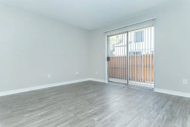 Explore the spacious interiors of Cali Crossing Apartments, where modern comfort meets style. Enjoy the serene sliding door that opens to your outside space and the sleek flooring that enhances your living experience. Schedule a tour today!
