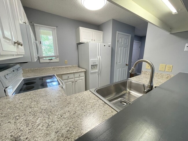 Photo - Updated, spacious 4br 2ba condo within wal... Unit G8