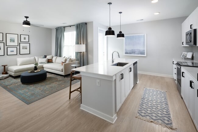 Kitchen, living, and dining areas with hard-surface vinyl plank flooring