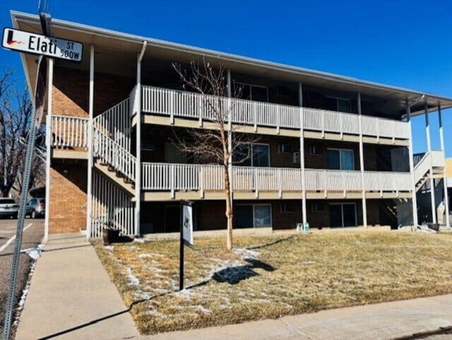 Bright, two-level urban apartment building with balconies and spacious surroundings on Elati Street.