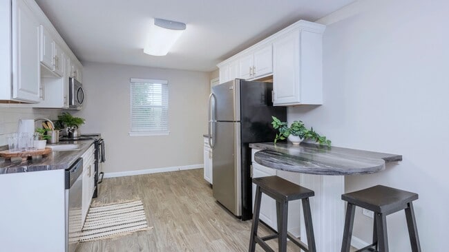 Embrace culinary elegance in Woodcrest Kitchens with the added charm of a breakfast bar.