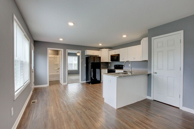 Photo - Two Story Duplex With Hardwood Flooring and White Cabinetry