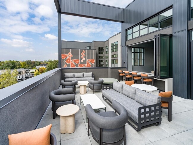 An inviting terrace at Modera University Park, designed for relaxed gatherings with neighborhood views and easy access to University Park below.