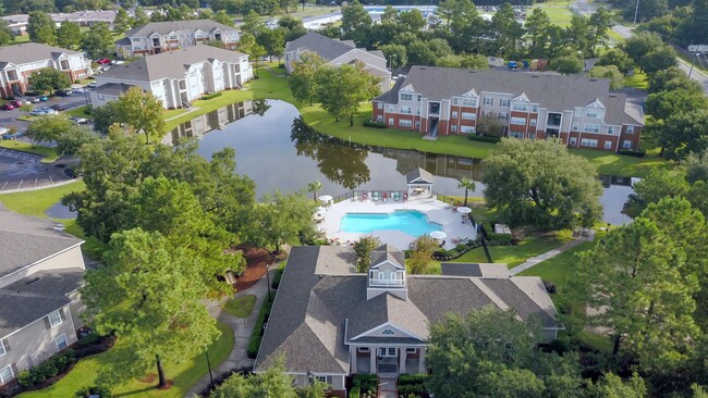 Savor the panoramic splendor of Eagle's Pointe in Brunswick, Georgia, from high above. An enchanting haven where the lake glistens, greenery flourishes, and a vibrant community thrives. - Eagles Pointe Apartments