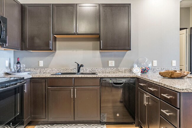 Our Espresso design style features rich, dark cabinetry and light granite countertops.