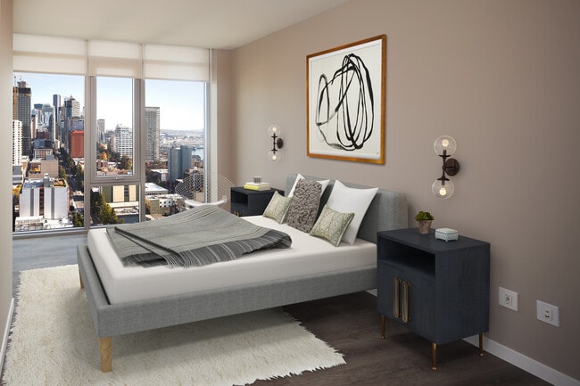 Signature Collection penthouse bedroom with floor-to-ceiling windows and hard surface flooring.