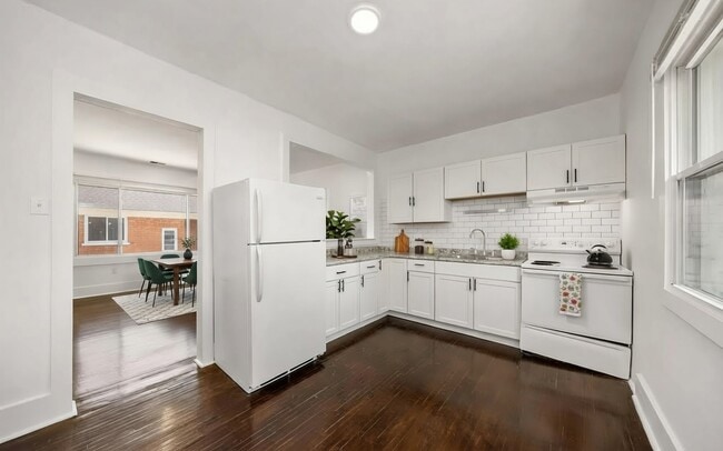 A sleek, updated kitchen. Image is virtually staged