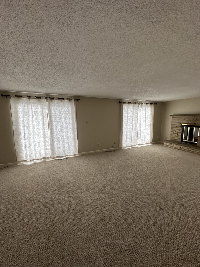 Living Room w/ Balcony Access - 1 Laura Ln Townhome