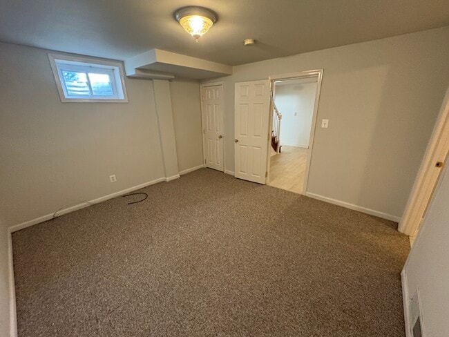 Bedroom or Living Room, with carpeting and closet - 201 E Indian Spring Dr Unit 1 - Yard - Utilities