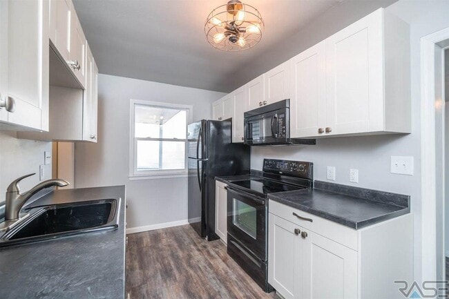 Kitchen with pantry, microwave, stove, oven, full size refrigerator, and soft close cabinets. - 2700 S Summit Ave