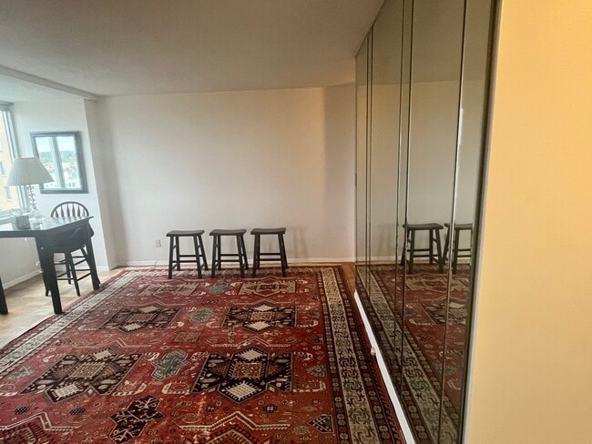 living room area with paneled wall ; large window DC vistas - 501 Slaters Ln Unit 1013