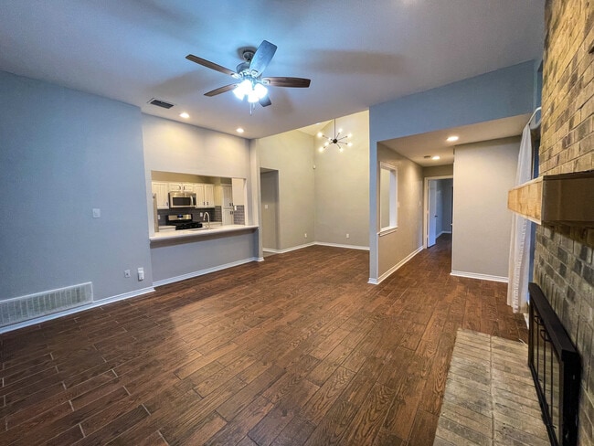 Open concept Kitchen, dining and living room. Features wood look tile throughout the home. scrapped ceilings, fresh interior paint, gas logs in the fire place and all new ceiling fans and light fixtures throughout. - 812 Via Madonna