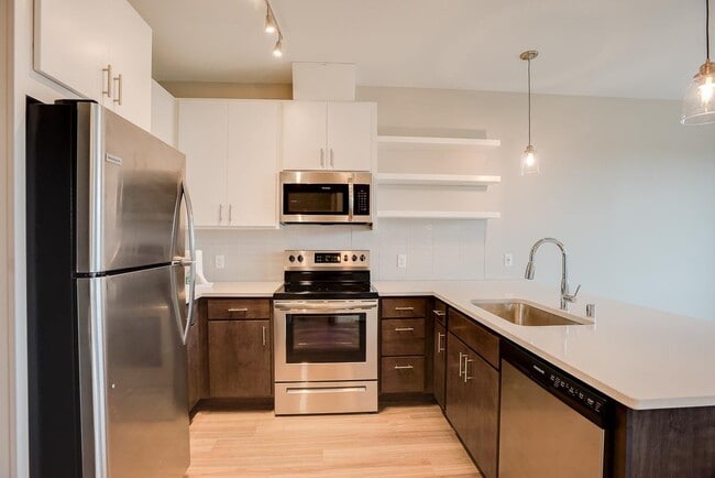 Cook and connect in our modern kitchens with granite countertops and sleek cabinetry.