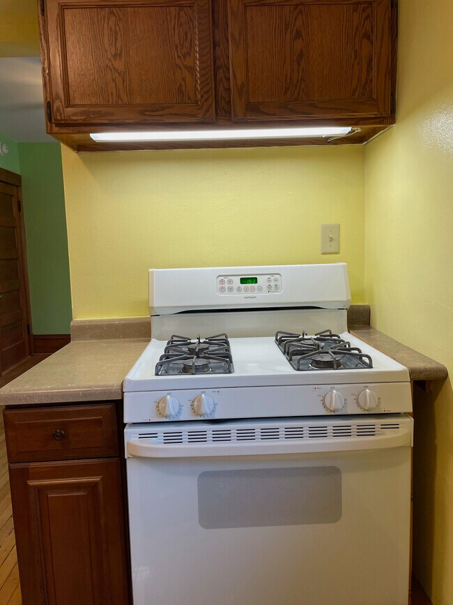 Full sized gas range with under cabinet lighting. - 236 Dunning St Unit 2