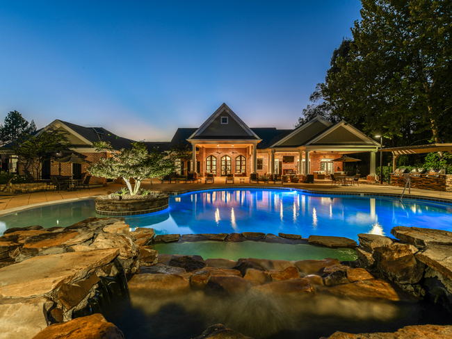 The Resort-Style Pool at Dusk - Walden at Providence Apartments